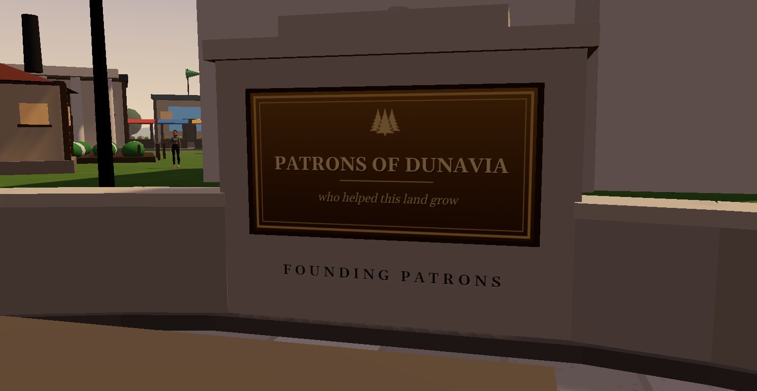 The bronze plaque on the plaza wall: Patrons of Dunavia, who helped this land grow. Founding Patrons is carved beneath it.